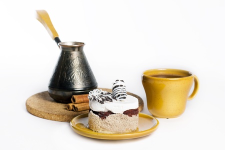 Tasty dessert on the round plate with cup of turkish coffe, isolated on white