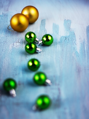 Christmas decoration with different balls on rusty craquelured wooden surfaceの写真素材
