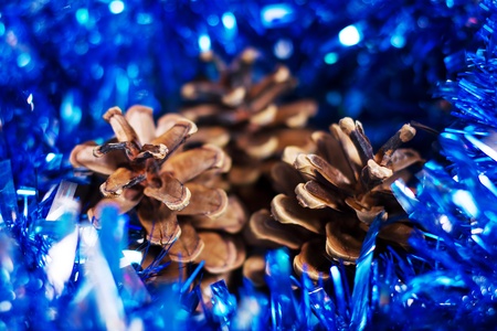 Christmas decoration with three cones and blue tinselの写真素材