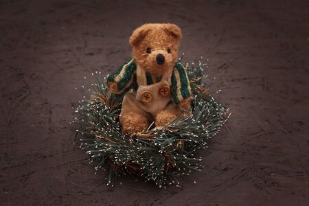 Christmas arrangement with a vintage teddy bear sitting in a wreathの写真素材