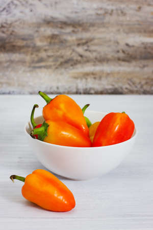 Group of ripe fresh peppers, on rusty wood background, selective focusの写真素材