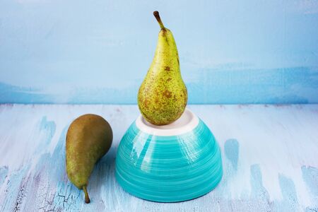 Two fresh juicy Conference Pears with blue backgroundの写真素材