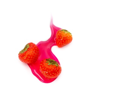 Red tasty strawberry in sweet syrup, isolated on whiteの写真素材