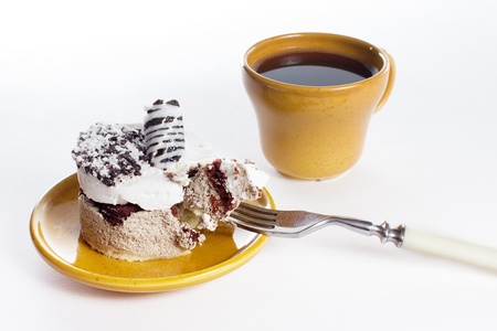Tasty dessert on the round plate with cup of coffe, isolated on whiteの写真素材
