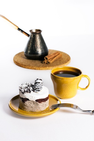 Tasty dessert on the round plate with cup of turkish coffe, isolated on whiteの写真素材