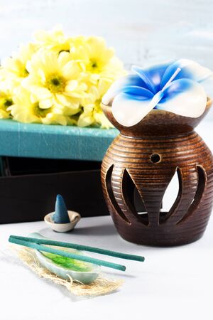Aromatherapy set with flower candle and incense, over whiteの写真素材