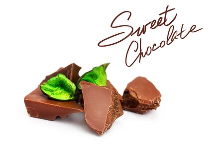 Chocolate pieces on a white background, with green decorの写真素材