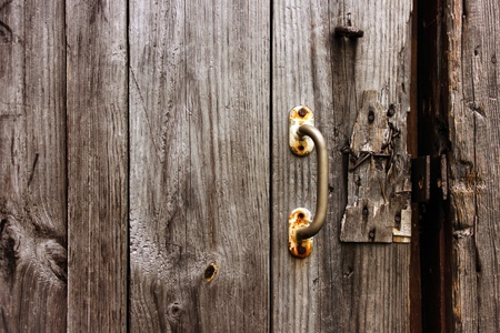 Old natural wooden texture with door handle. Broken door lock.の写真素材