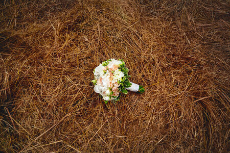 Gentle wedding flowers on the hay field. Rustic style.の写真素材