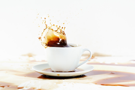 Cup of coffee creating splash  White background, coffee stains  Coffee break, breakfast concept  の写真素材