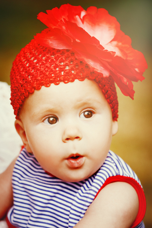 Adorable little baby girl with big eyes. Close up portrait. One or two years old.の写真素材