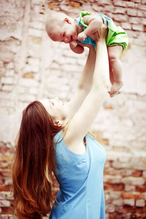 Beautiful young woman playing with baby. Happy family. の写真素材