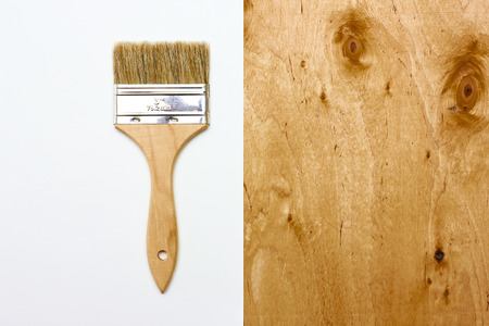 Renovation brush with white paper and wooden texture. Space for your text.の写真素材