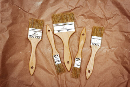 Set of five different renovation brushes on craft paperの写真素材