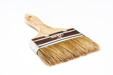 Renovation paintbrush on white background. Selective focus.