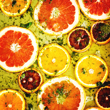 Square background from ripe red oranges and grapefruits.   の写真素材