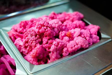 Cooked color pink cauliflower in metallic dish. Street healthy food.