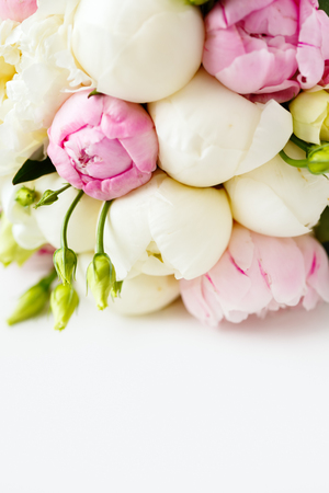 Wedding bouquet of ranunculus and peony flowers on white background. Space for text. Selective focus.の写真素材