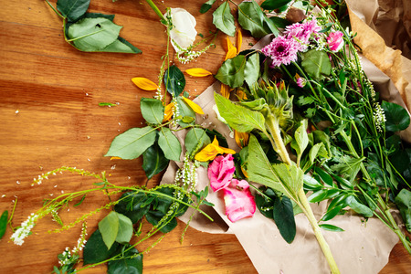 Fresh flowers on wooden table. Florist workplace.の写真素材