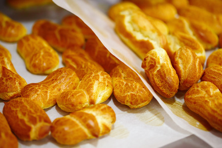 Fresh Baked Eclairs ready for Topping. Selective focus.の写真素材