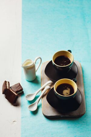 Morning Coffee Table. Two Cups of Espresso with Chocolate Cake and Milk Jug. Selective focus, top view.の写真素材