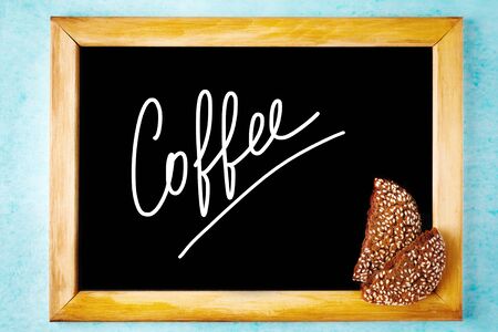 Background with Chalk Board with White Text Coffee in Wooden Frame with Chocolate Cookie Pieces. Menu Concept.の写真素材
