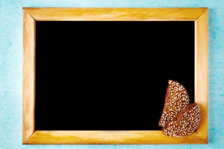 Background with Chalk Board in Wooden Frame with Chocolate Cookie Pieces. Menu Concept. Space for text.の写真素材