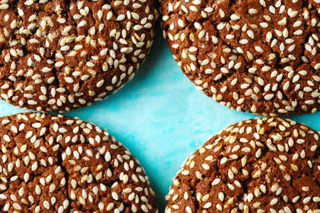 Food Background with Cookie Pieces with Sesame cracked on Two Halves on Blue Background. Macro shot. Space for text.の写真素材