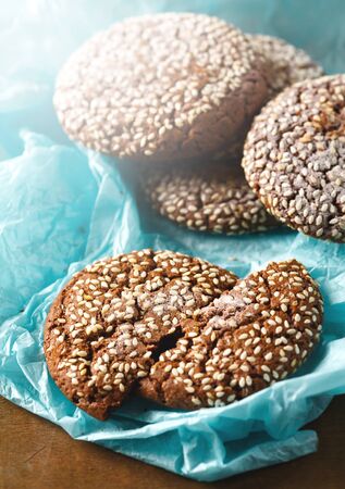 Healthy Fresh Baked Cookies with Sesame on Blue Paper Background. Close up.の写真素材
