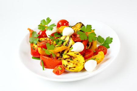 Grilled vegetables with mozzarella cheese. Cherry tomatoes, pepper, eggplant, zucchini served with fresh herbs.の写真素材