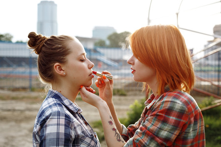 Makeup Artist Applying Red Lipstick on Lips of a Beautiful Woman. Pin Up Style.の写真素材