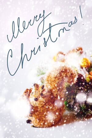 Christmas Background with Hand Made Toy Squirrel. Drawn Snow for Festive Mood. Image with Text "Merry Christmas!"の写真素材