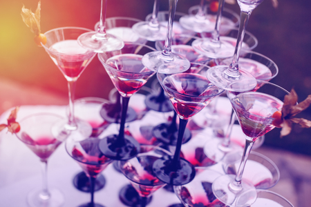 Pyramid of Champagne Glasses with Color Cocktails. Wedding Reception. Selective Focus.の写真素材