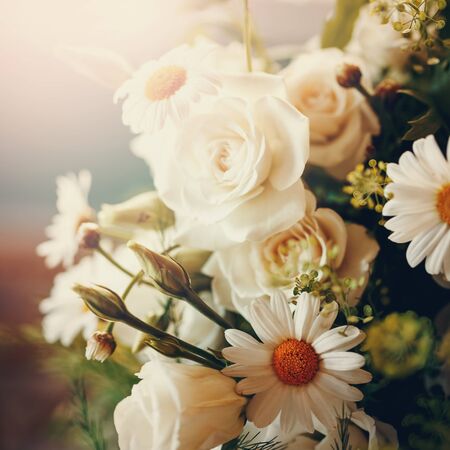 Fresh Bouquet of White Roses and Chamomile Close Up. Selective Focus, Shallow Depth of Field. Space for Text.の写真素材