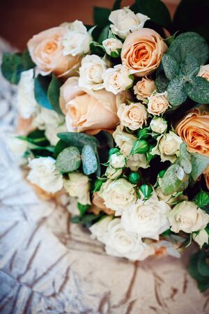 Bouquet with White and Cream Roses and Fresh Green Leaves. Selective Focus, Shallow Depth of Field.の写真素材