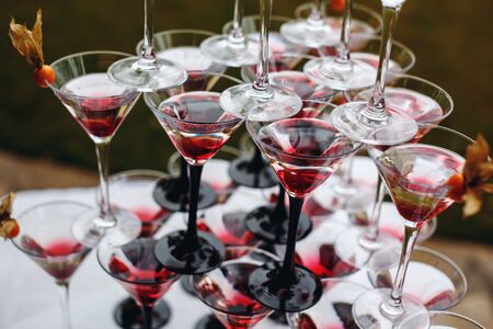 Rows of Champagne Glasses with Color Cocktails. Wedding Reception. Selective Focus.の写真素材
