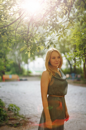 Young Romantic Meditative Female in Summer Evening. Outdoor Portrait with Backlight. Space for Your Text. Selective Focus.の写真素材