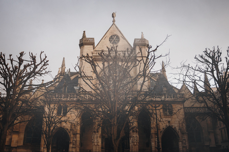 Facade and Sculptures of The Church of Saint-Germain l'Auxerrois after Rain. Paris, France. Gothic Background, Image Toned.の写真素材