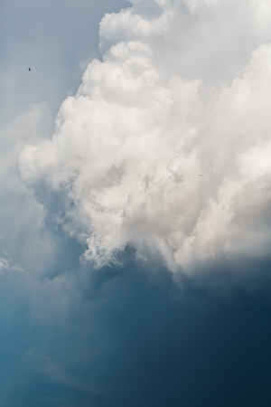 Blue Sky with Stormy Cumulus Clouds. Majestic Background. Selective Focus.の写真素材