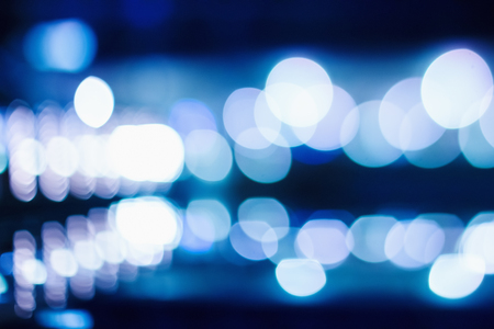 Blue Bokeh Lights on Dark Background. Defocused Blurred City Lights.の写真素材