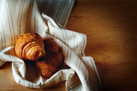 Freshly Baked Homemade French Croissants on a Tablecloth. Selective Focus.の写真素材