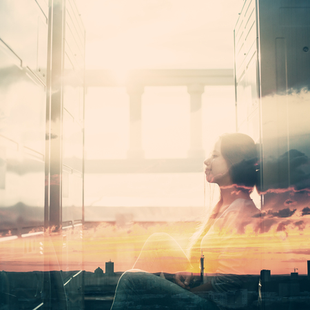 Abstract Portrait of Young Woman with Double Exposure Effect. Combined with Sunset Sky, Toned with Vintage  Colors.の写真素材