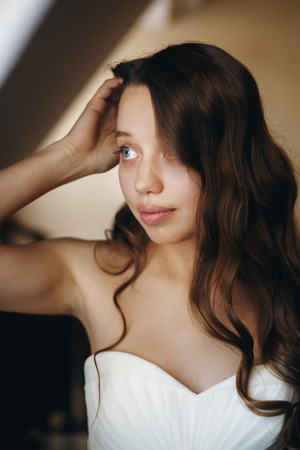 Wedding Day. Portrait of Young Gentle Bride Looking Away. Curly Hair Style. Selective Focus.の写真素材