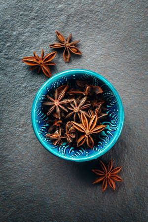 Authentic Blue Bowl Full of Anise Stars. Spice Background. Top View.の写真素材
