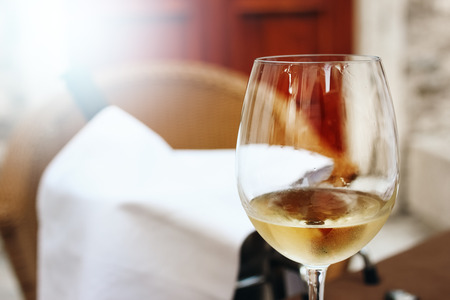 Close-up of Glass of White Wine in Street Cafe. Copyspace.の写真素材