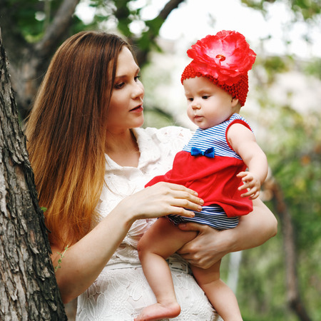 Beautiful Happy Mother and Daughter Together in Parkの写真素材