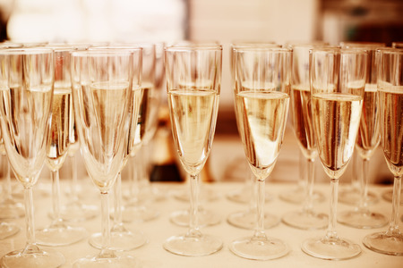 Rows of Champagne Glasses Served on Event. Image Toned with Gold Colors. Selective Focus.の写真素材