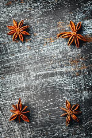 Composition with Star Anise on vintage black texture. View from above. Space for text, great frame for menu.の写真素材