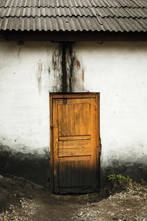 Old abandoned house with wooden doorの写真素材