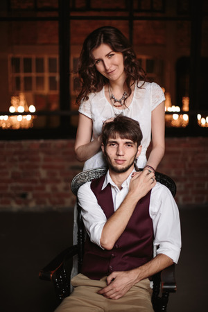Stylish wedding couple, groom and bride together. Embracing in loft interior at background. Selective focus.の写真素材